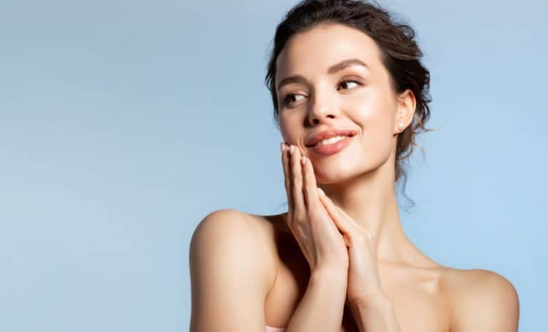 a woman touches her face